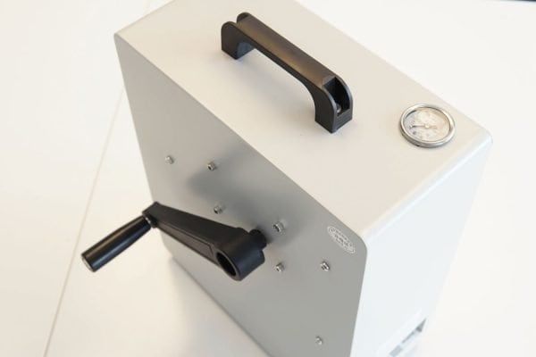 Portable sterilizer machine for medical, dental, and laboratory use with temperature and pressure gauges. Compact sterilization device for efficient infection control.